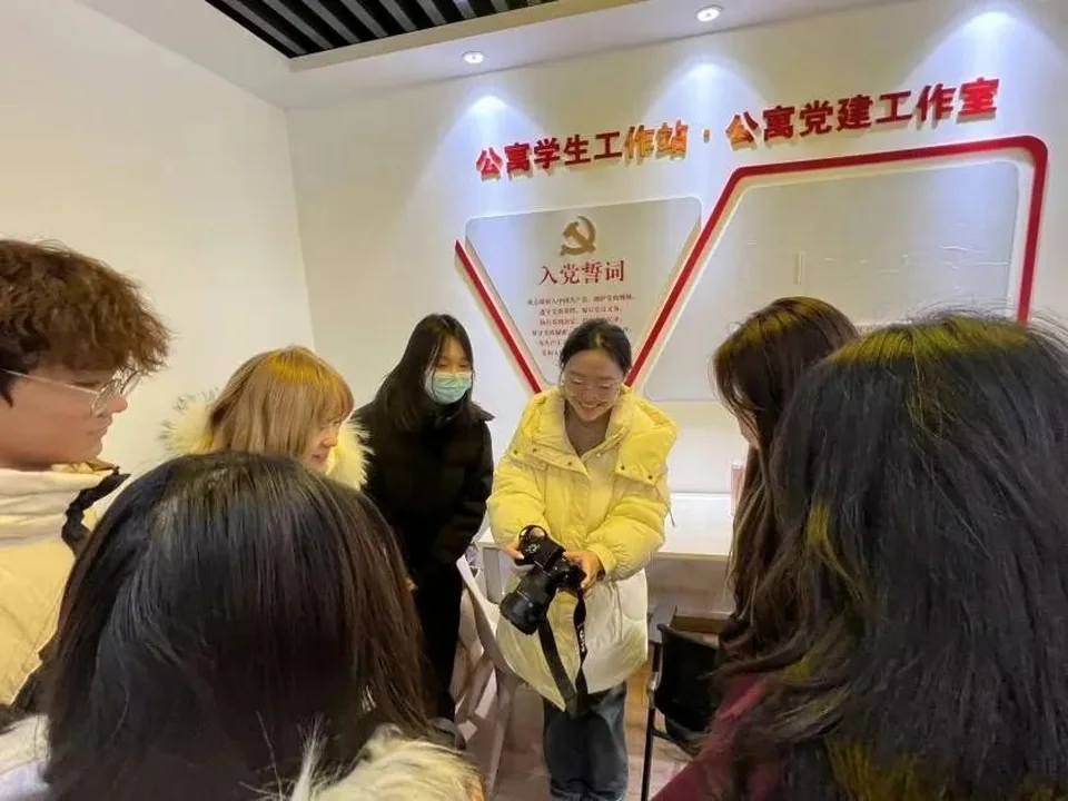 同学们在摄影技能活动中操作相机